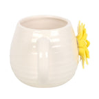 White ceramic mug with a yellow sunflower design on a white background