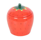 Strawberry-shaped candle container with a green lid on a white background