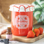 Jar of strawberry jam oil burner with a dropper bottle and strawberries on a wooden board
