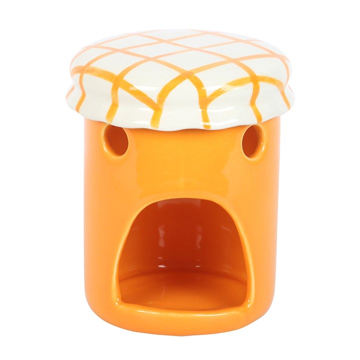Orange ceramic jar shaped oil burner with a white and orange checkered lid on a white background