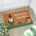 Coir doormat with a gnome design and 'Welcome Gnome' text on a wooden floor.