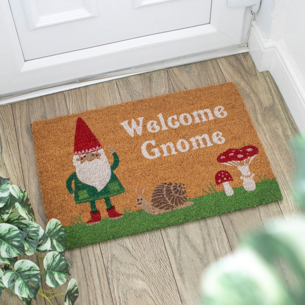 Coir doormat with a gnome design and 'Welcome Gnome' text on a wooden floor.