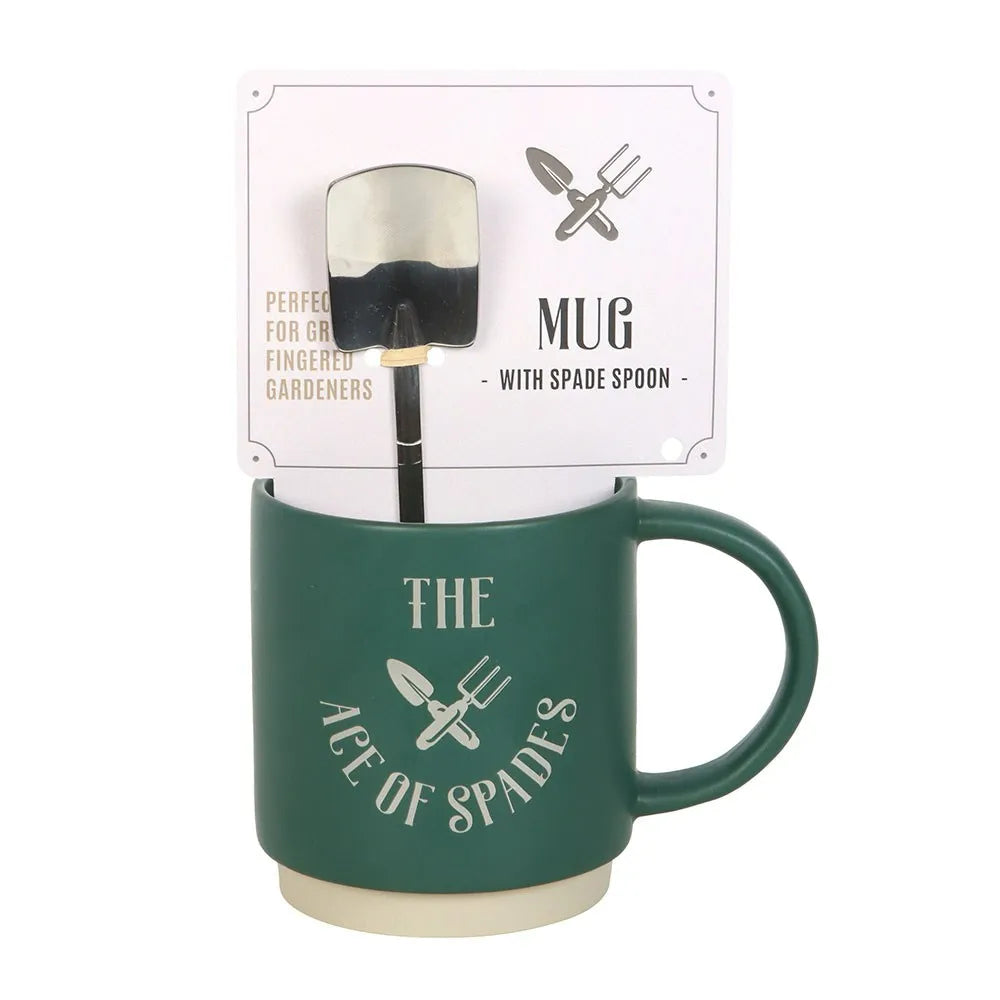 Green mug with spade spoon on a white background