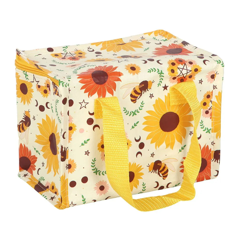 A square soft-sided insulated lunch bag with a cream background and a colourful sunflower, bee, and floral print. It features two bright yellow fabric handles and a matching yellow zipper.