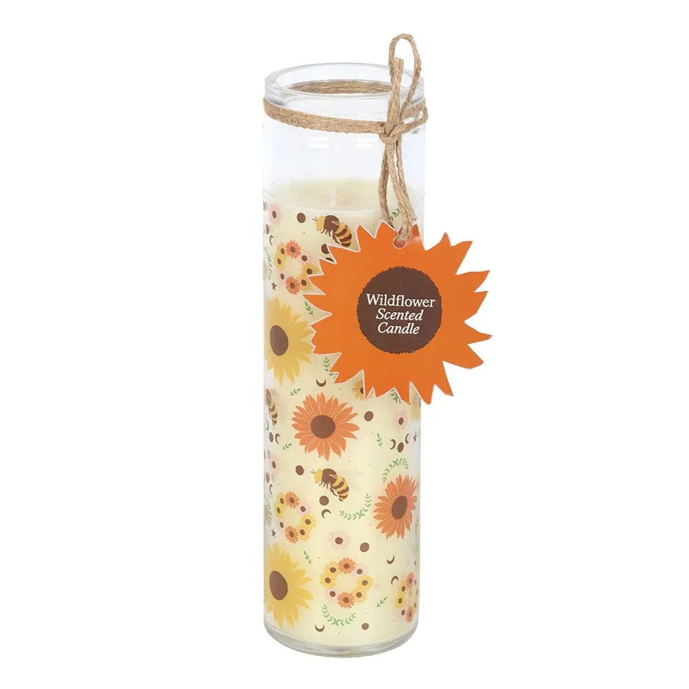 Decorative glass tube candle with floral and bee design and a label on a white background