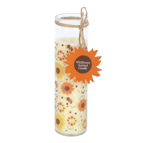 Decorative glass tube candle with floral and bee design and a label on a white background
