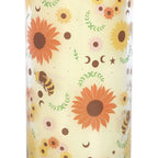 Glass tube candle with sunflower and bee pattern on a beige background