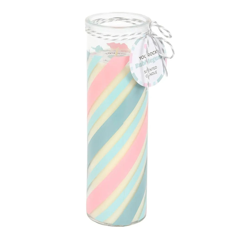 Glass tube candle with pastel pink and blue striped candle and decorative tag on a white background