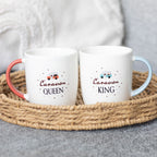 Two mugs labelled 'Caravan Queen' and 'Caravan King' with coloured handles