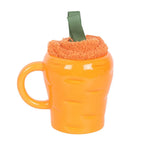 Carrot-shaped mug with a fluffy socks against a white background