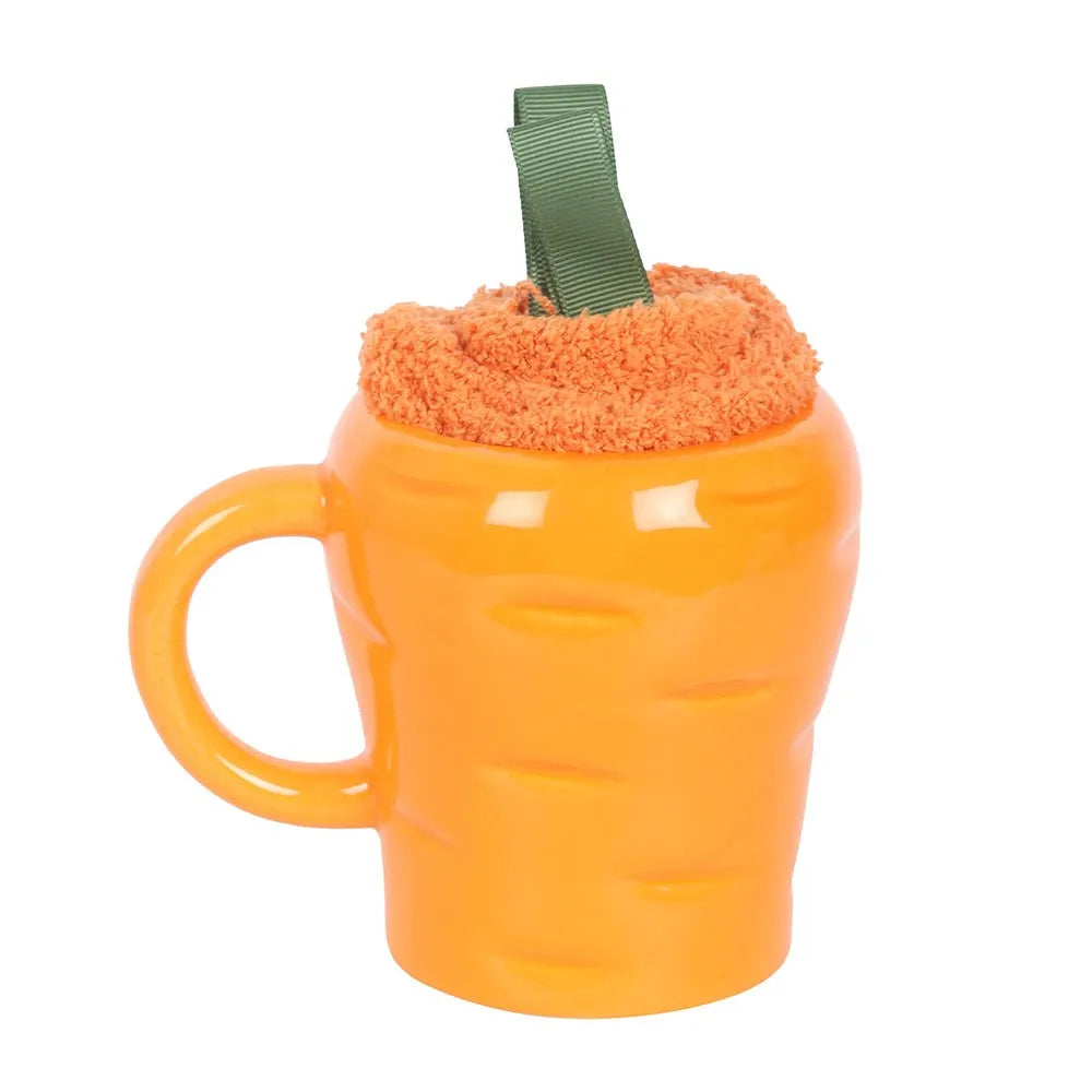 Carrot-shaped mug with a fluffy socks against a white background