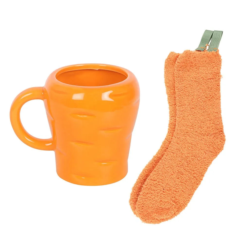 Orange carrot shaped mug and fluffy sock set on a white background