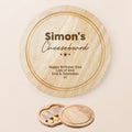 Personalized round wooden cheeseboard set with engraved text personalised with name and message of choice , shown closed on a light beige background with a smaller inset of the three cheese knives in their matching wooden holder.