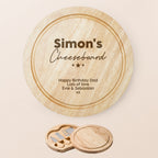 Personalized round wooden cheeseboard set with engraved text personalised with name and message of choice , shown closed on a light beige background with a smaller inset of the three cheese knives in their matching wooden holder.