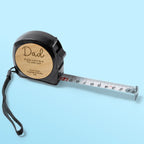 Measuring tape with wooden engraved label on a light blue background