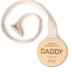 Wooden medal with 'Officially the world's best daddy' text on a white background