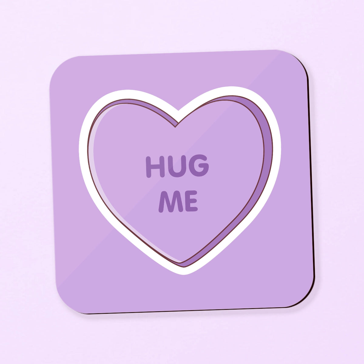 square coaster with love heart inspired design saying 'hug me' on a purple background