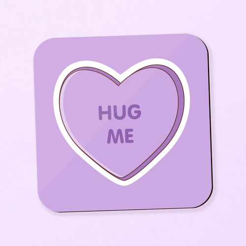 square coaster with love heart inspired design saying 'hug me' on a purple background