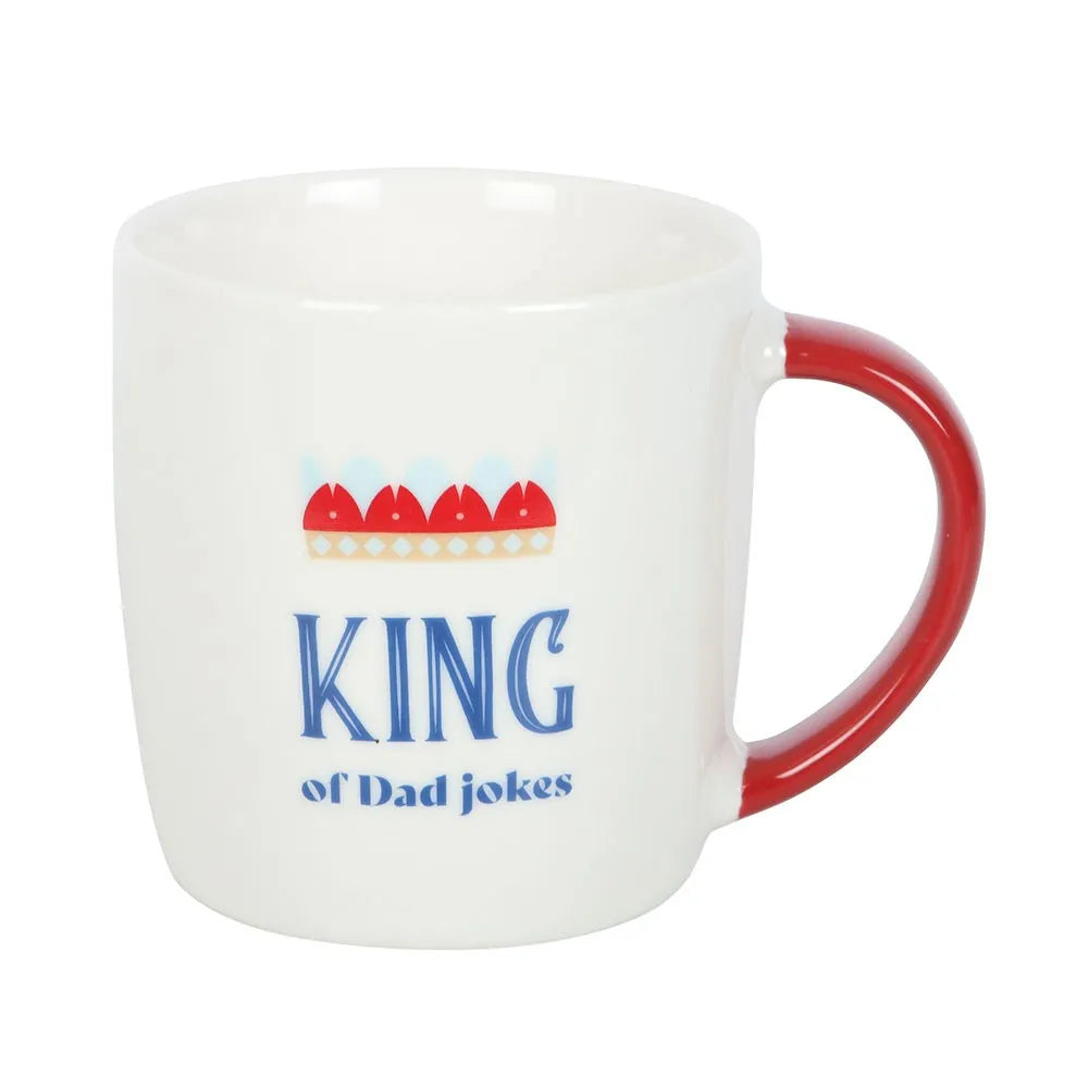 White mug with red handle featuring colourful 'king of dad jokes' text and graphics on a white background