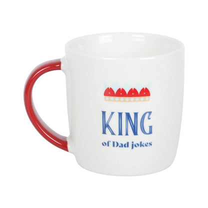 White mug with red handle featuring 'King of Dad Jokes' text and graphics on a white background