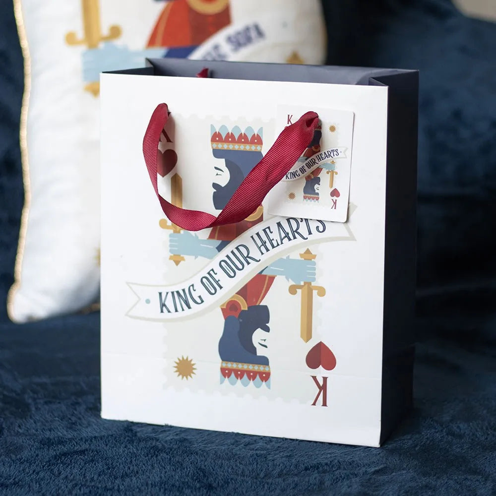 Gift bag with 'King of Our Hearts' text and design on a blue fabric background