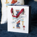 Gift bag with 'King of Our Hearts' text and design on a blue fabric background