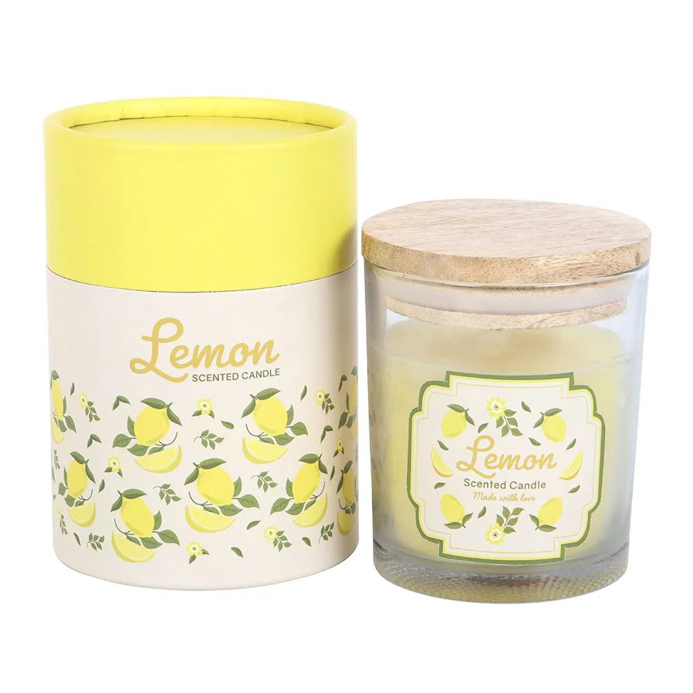 lemon scented candle in a glass jar with a wooden lid. Next to its packaging