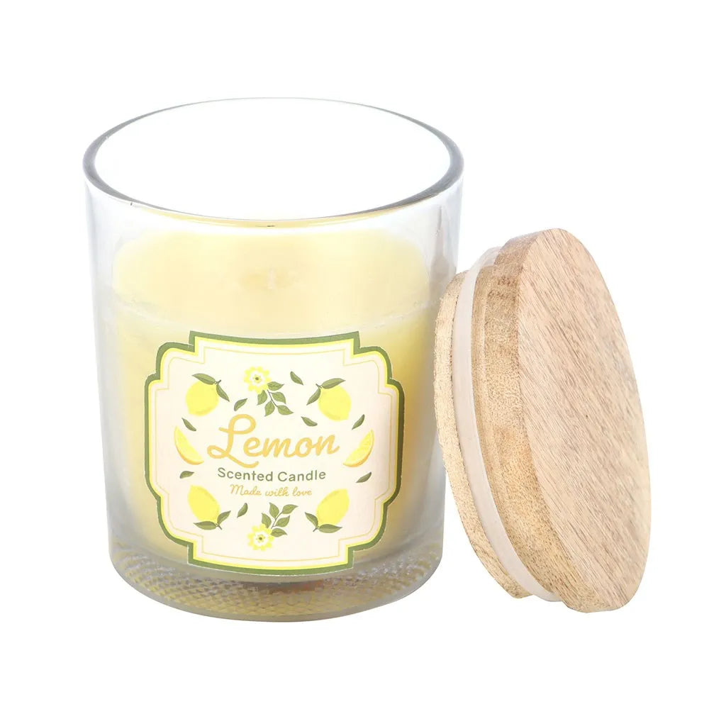 Lemon scented candle in a glass jar with a wooden lid on a white background