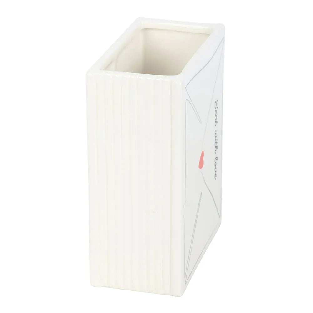 White rectangular vase with a red label on a white background
