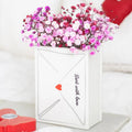 White envelope-shaped vase with pink and red flowers, 'Sent with love' text, and a red heart on a white background.