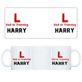 White mug with 'Dad in Training' text and logos on a white background