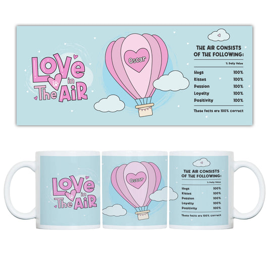Mug with 'Love in the Air' design featuring a pink hot air balloon and text on a light blue background.