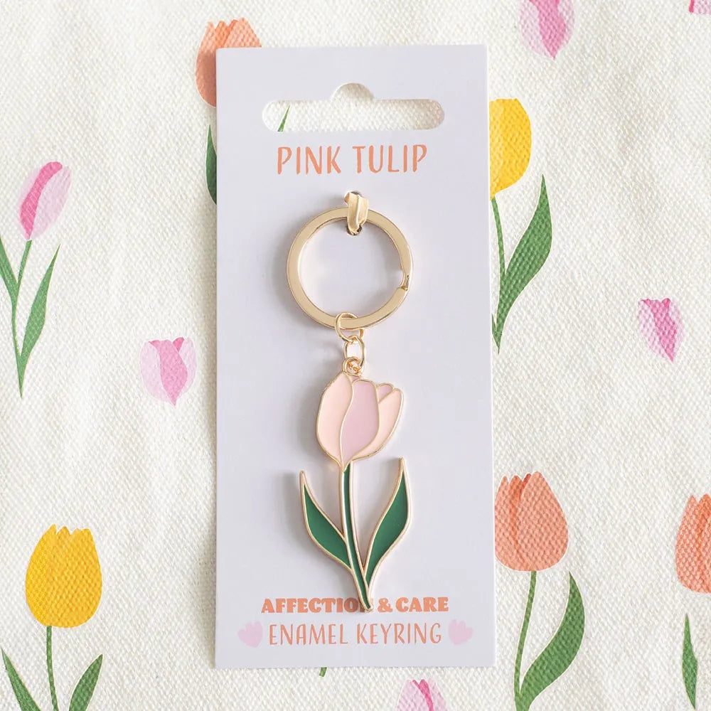 Pink tulip keychain on a branded card with floral design