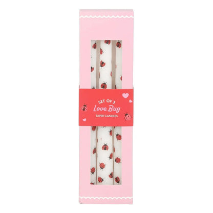 Set of 3 love bug taper candles in a pink packaging box with a red label.