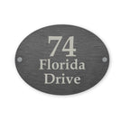 Slate house sign with '74 Florida Drive' text on a white background
