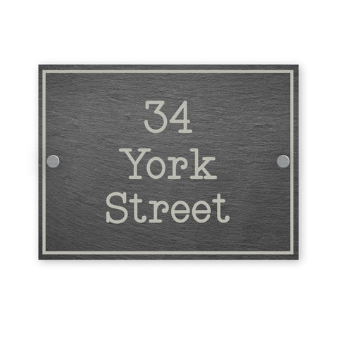 Gray rectangular house number sign with '34 York Street' text on a white background