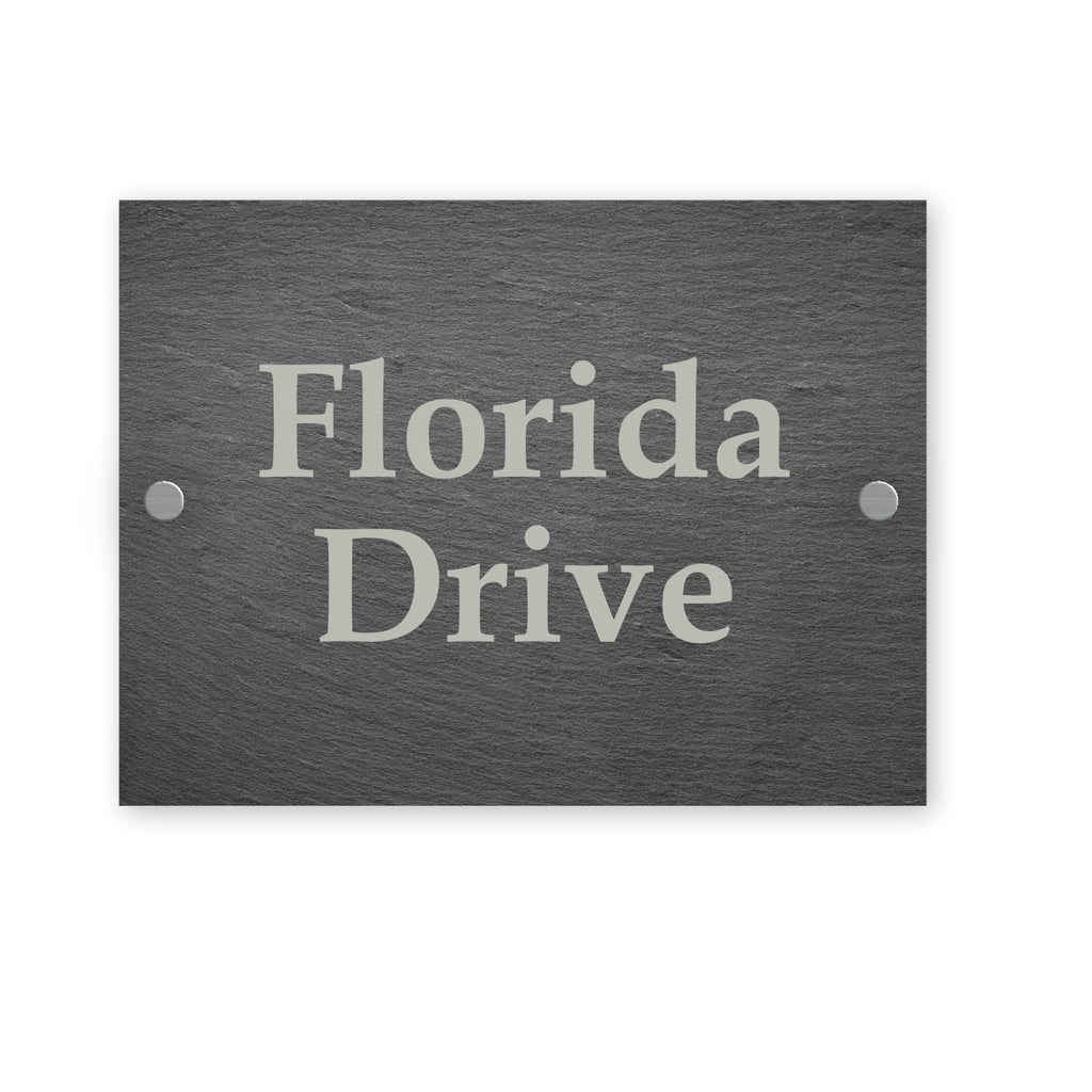 Dark grey slate sign with house name engraved on a white background