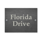 Dark grey slate sign with house name engraved on a white background