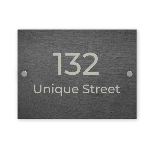 Slate rectangular house number sign with '132 Unique Street' on a white background