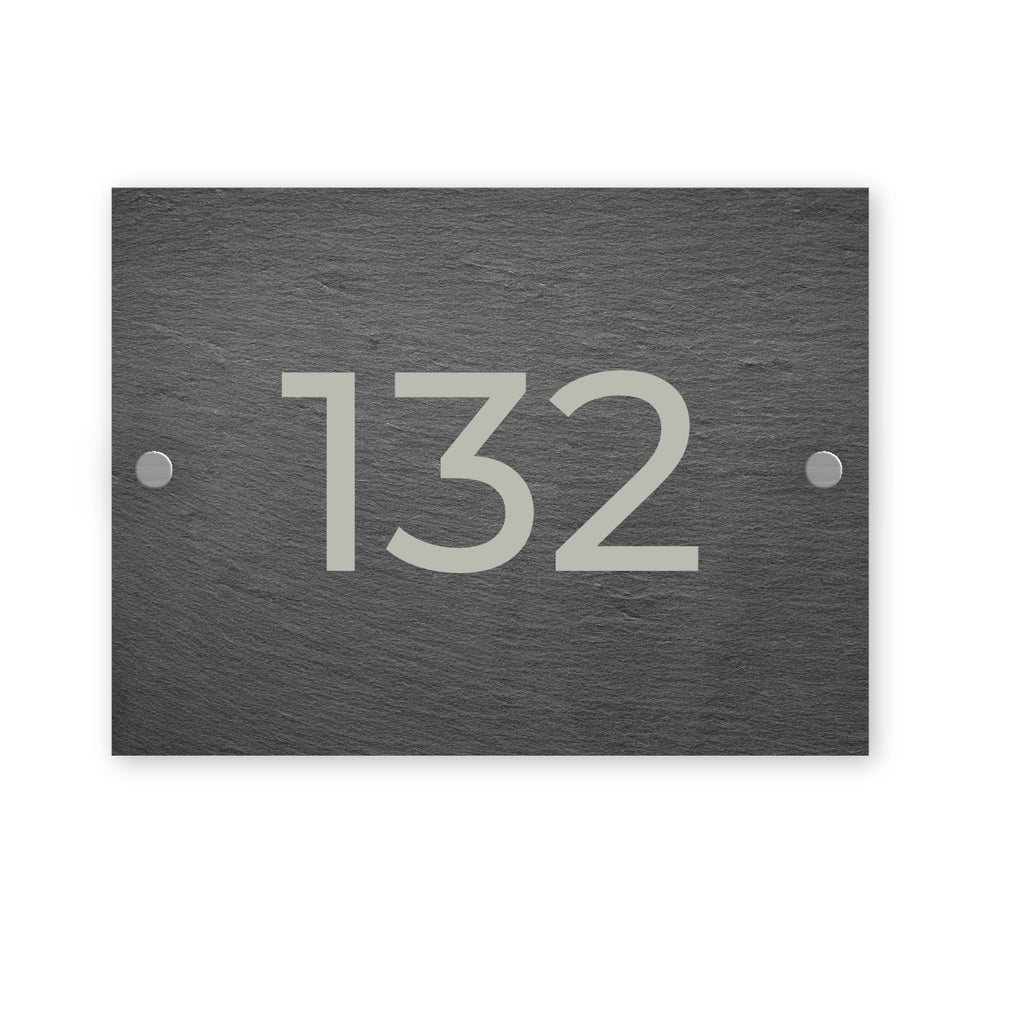 Slate house number sign with the number 132 on a white background