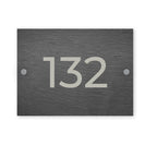 Slate house number sign with the number 132 on a white background