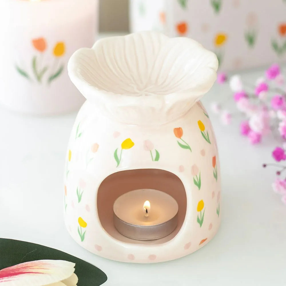tulip-shaped ceramic warmer with floral patterns on a white background