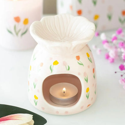tulip-shaped ceramic warmer with floral patterns on a white background