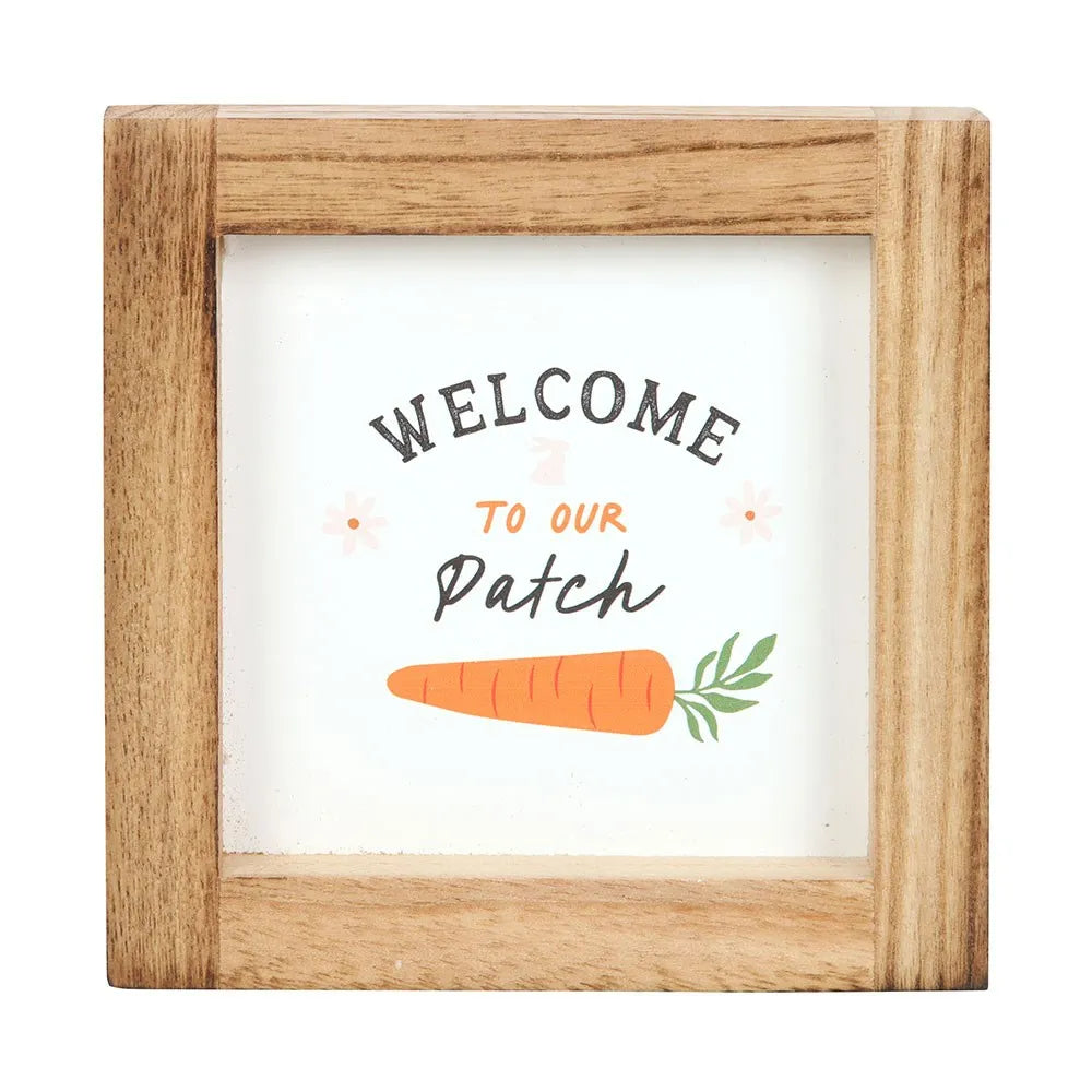 Wooden-framed sign with 'Welcome to our Patch' text and a carrot illustration on a white background.