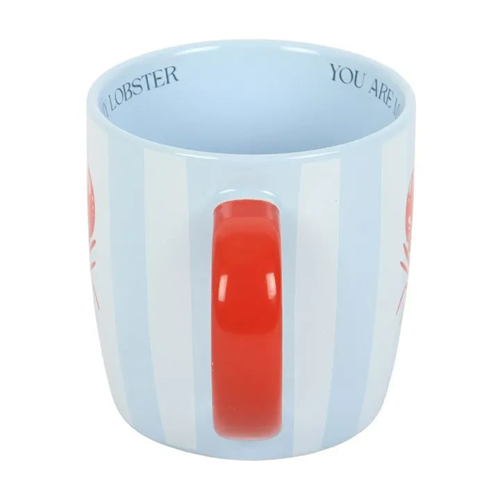 Blue mug with red handle and text on a white background